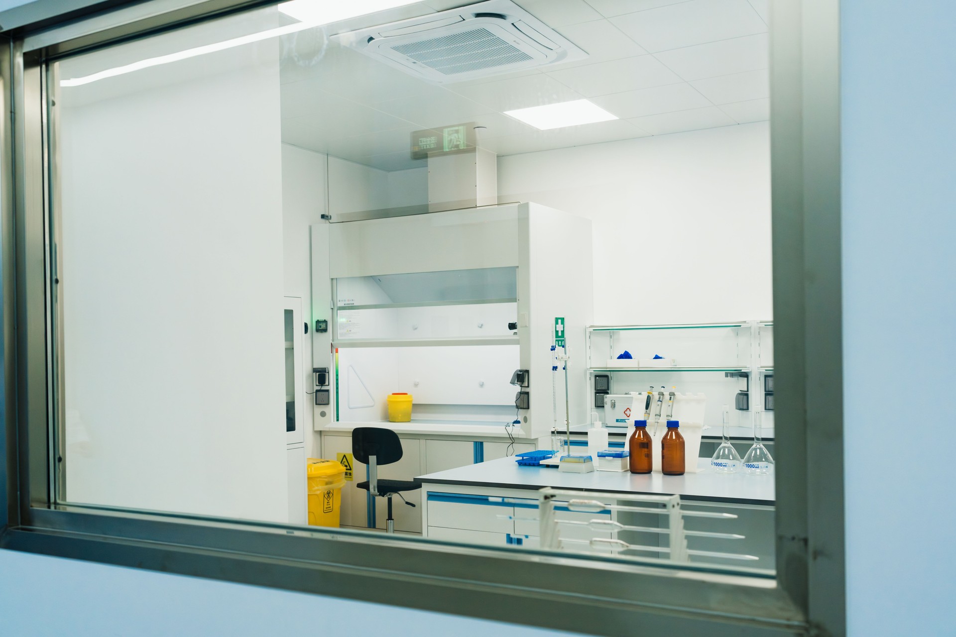 Empty science lab with biotechnology computer, equipment and workspace with no people.